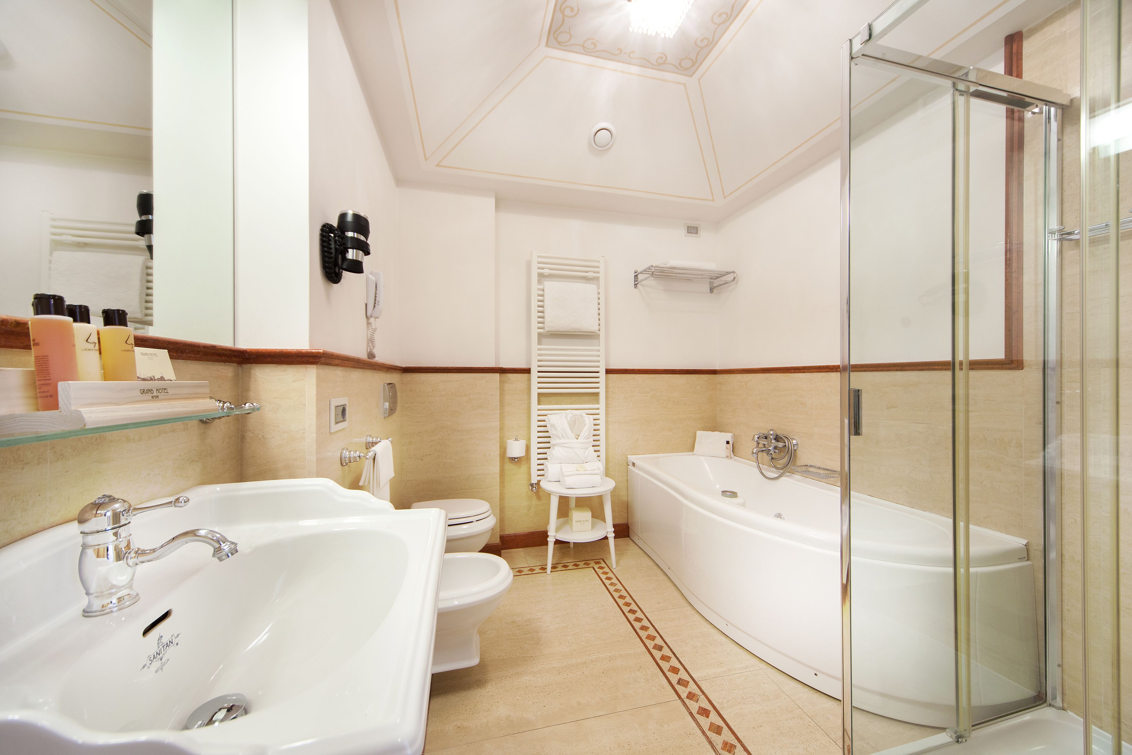 A bathroom with a large sink, toilet, and bathtub.