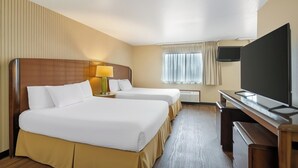 A hotel room with two beds, a desk with a flat-screen TV, a lamp, and a window with curtains. - Red Lion Hotel Rogue Regency Medford Airport (Medford)