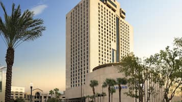Edifício de hotel alto e moderno com fachada plana e entrada imponente.