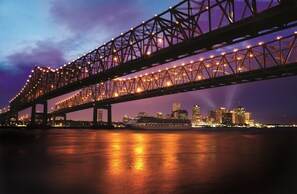A large bridge with multiple light fixtures and a city skyline in the background. - Hilton New Orleans Riverside (New Orleans)