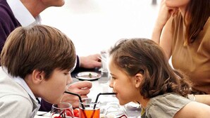 A family dining at a restaurant with a table set for four. - Novotel Paris Rueil Malmaison (Rueil-Malmaison)