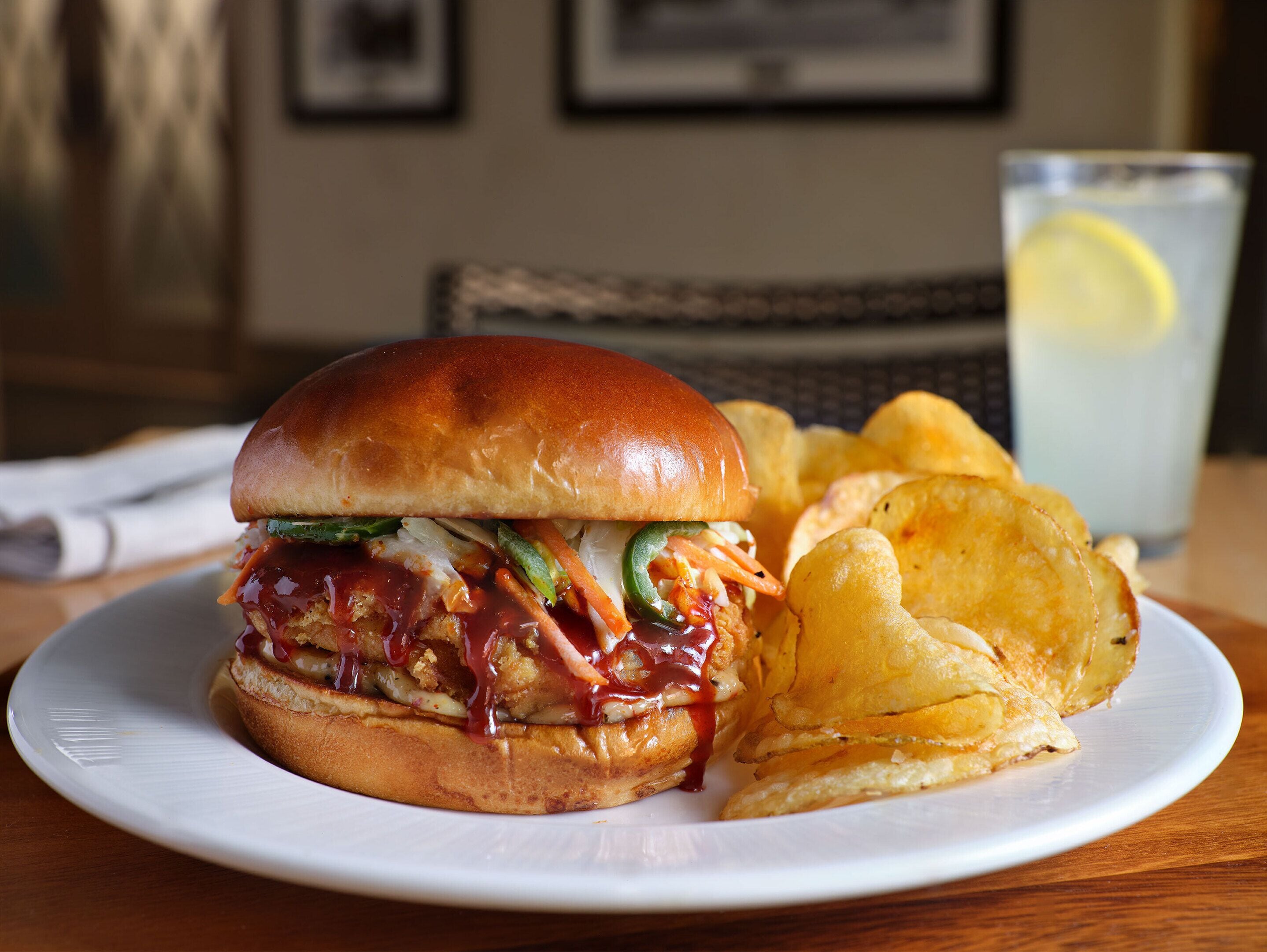 A plate with a sandwich and chips.