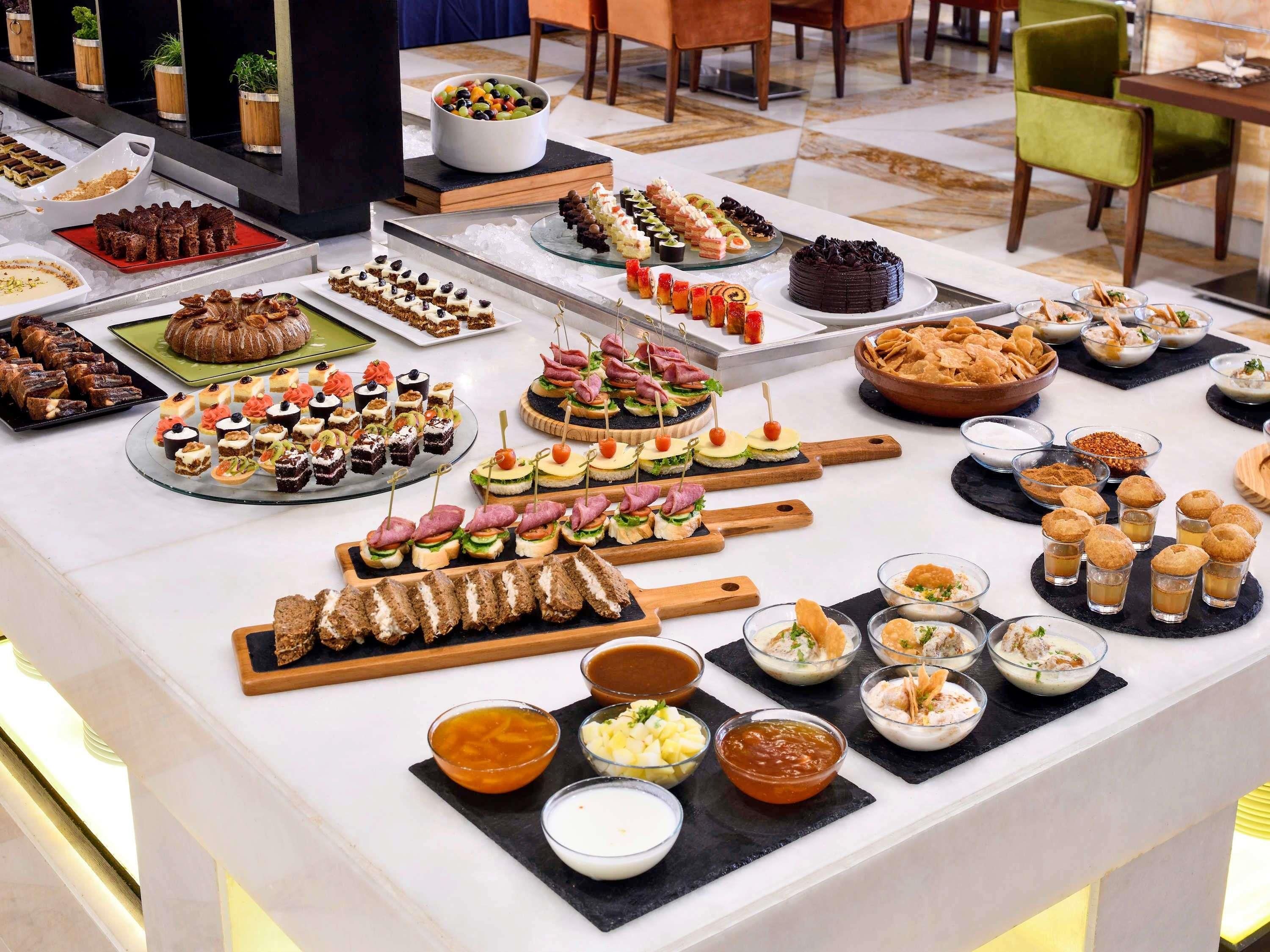 A buffet with a variety of food items and beverages.