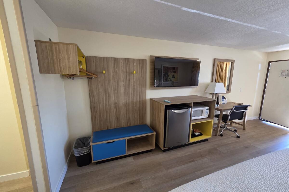 Desk, laptop workspace, blackout drapes, iron/ironing board