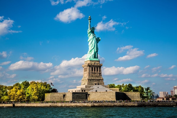 The Statue of Liberty in New York City, surrounded by water and a stone pedestal.