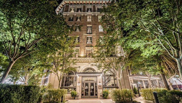 A historic building with a grand entrance, large windows, and a well-maintained garden. - The Culver Hotel (Culver City)