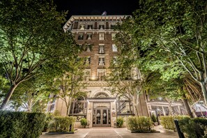 A historic building with a grand entrance, large windows, and a well-maintained garden. - The Culver Hotel (Culver City)