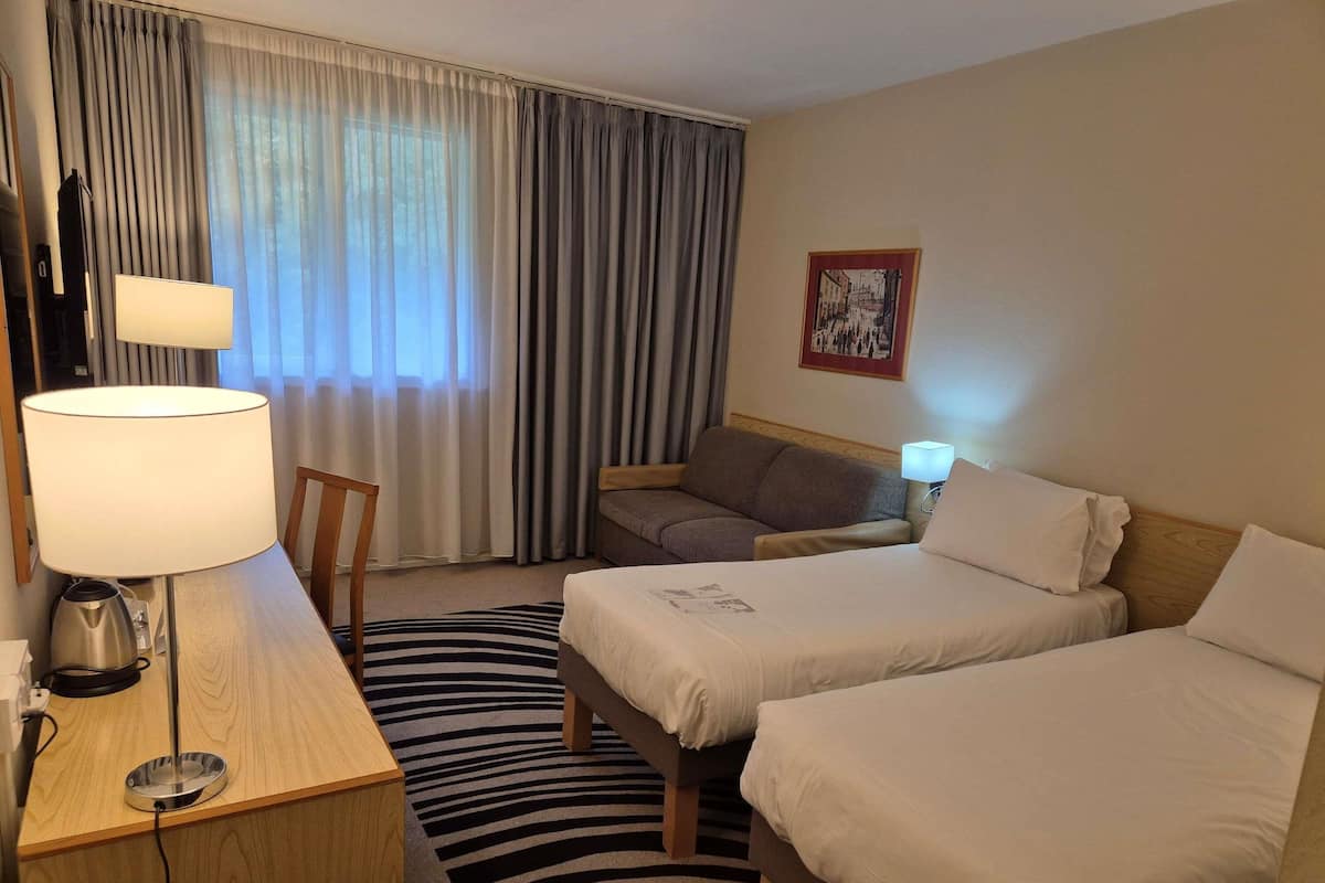 Hypo-allergenic bedding, desk, laptop workspace, blackout curtains