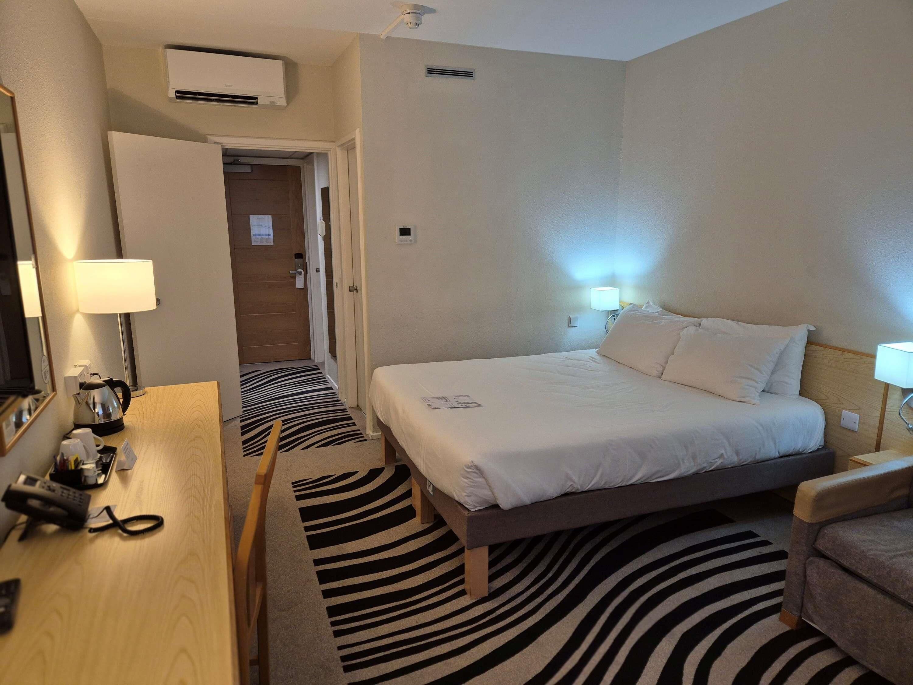 Hypo-allergenic bedding, desk, laptop workspace, blackout drapes