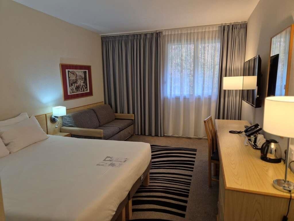 Hypo-allergenic bedding, desk, laptop workspace, blackout drapes