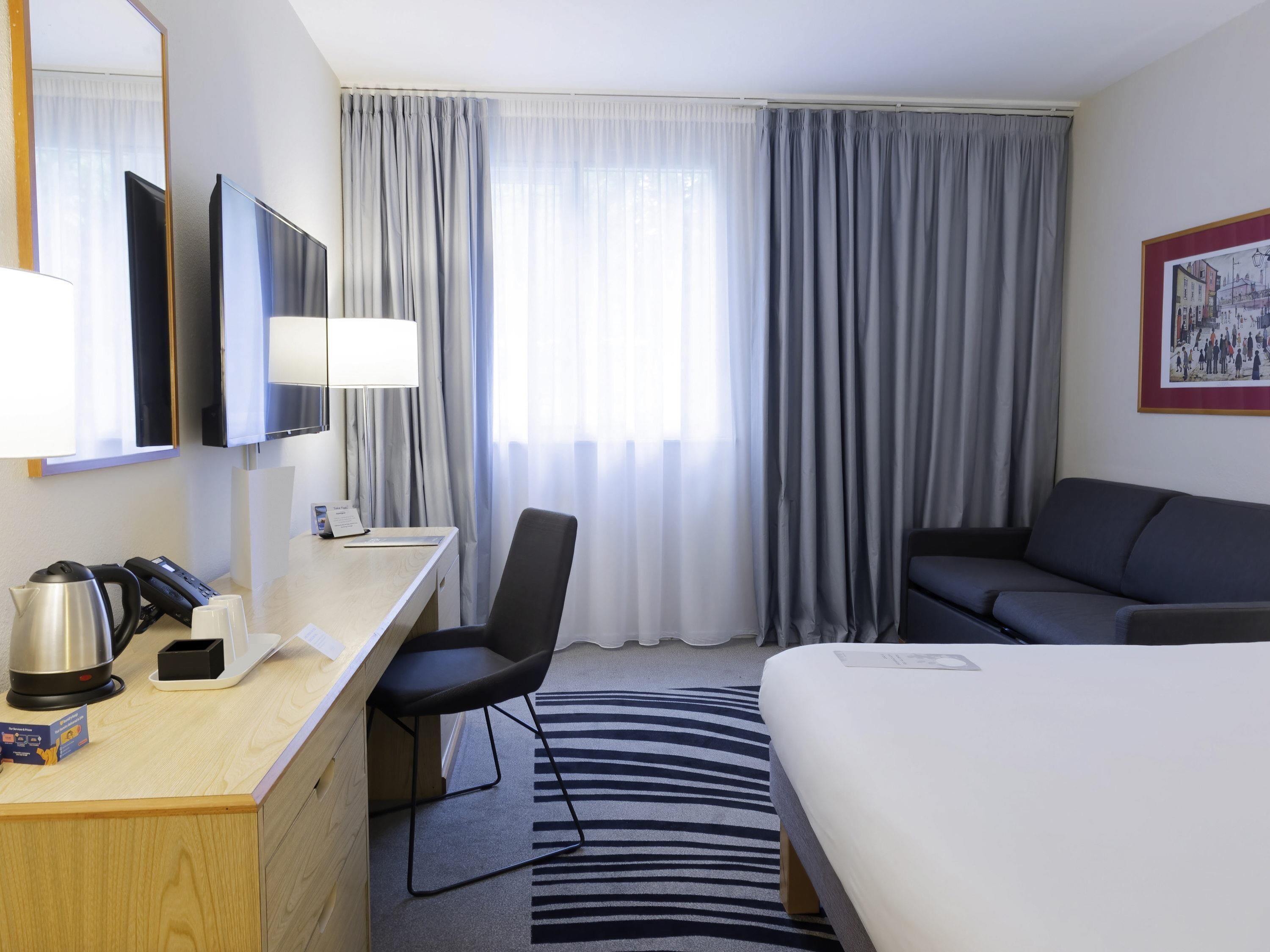 Hypo-allergenic bedding, desk, laptop workspace, blackout drapes