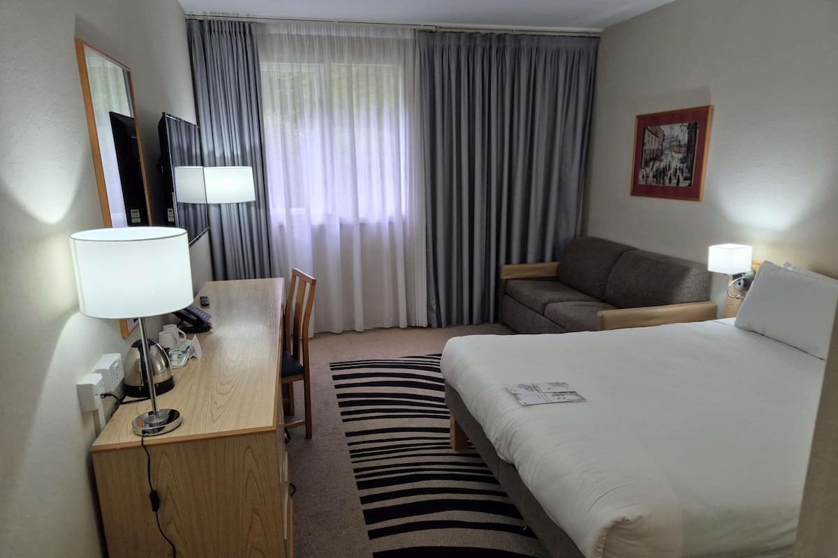 Hypo-allergenic bedding, desk, laptop workspace, blackout curtains