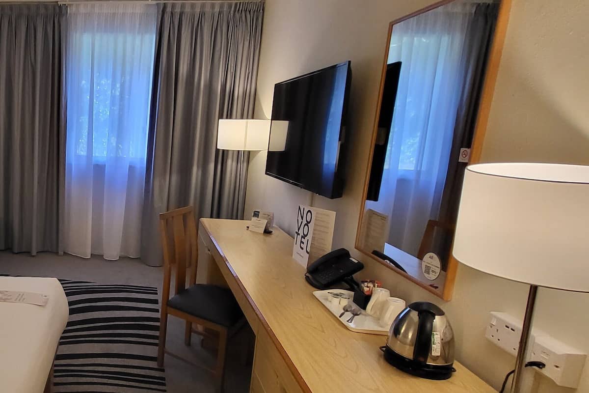 hypo-allergenic bedding, desk, laptop workspace, blackout curtains