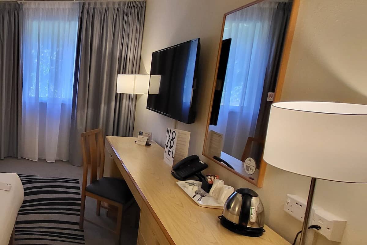 Hypo-allergenic bedding, desk, laptop workspace, blackout drapes
