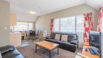 Apartment, 2 Bedrooms | Living area | 32-inch flat-screen TV with satellite channels, TV, books