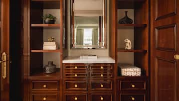 A wooden vanity with a mirror, shelves, and drawers.