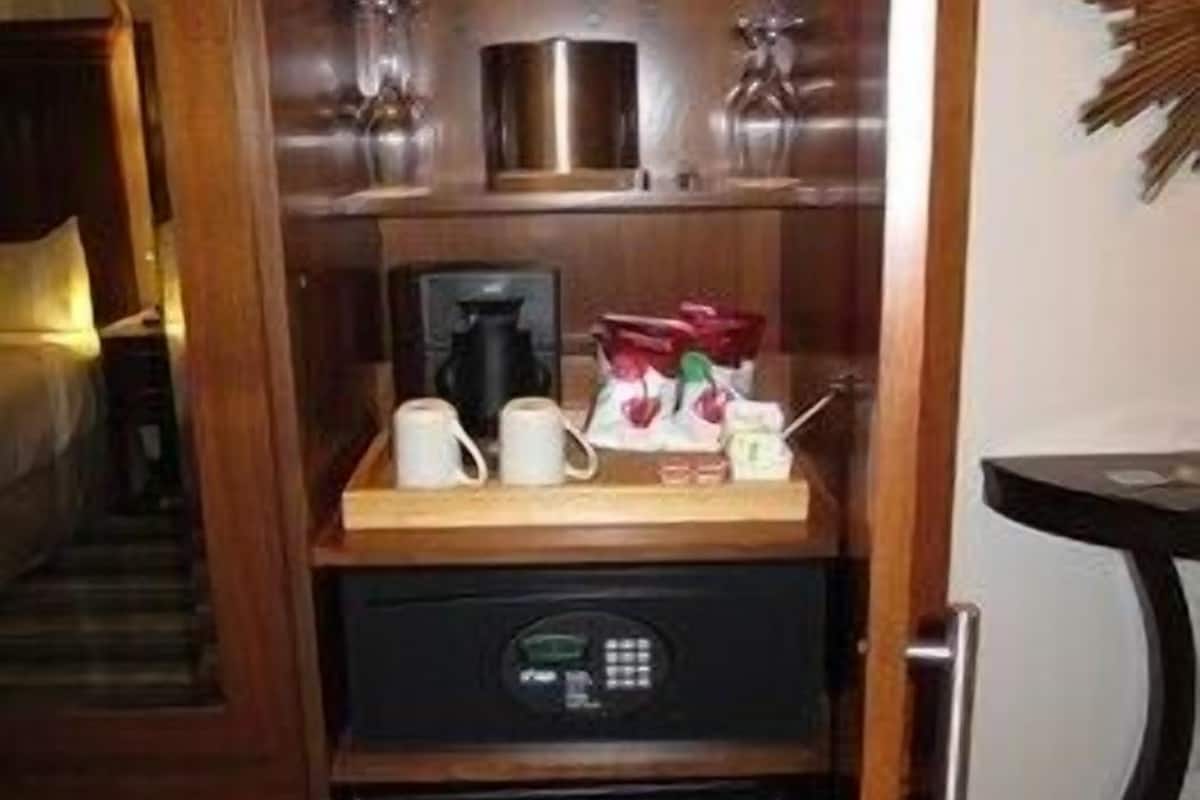 A compact kitchen with a coffee maker, a microwave, and a small refrigerator.