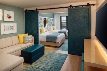 A modern kitchen with a large island, stainless steel appliances, and a wine bottle on the counter. at The Alfond Inn
