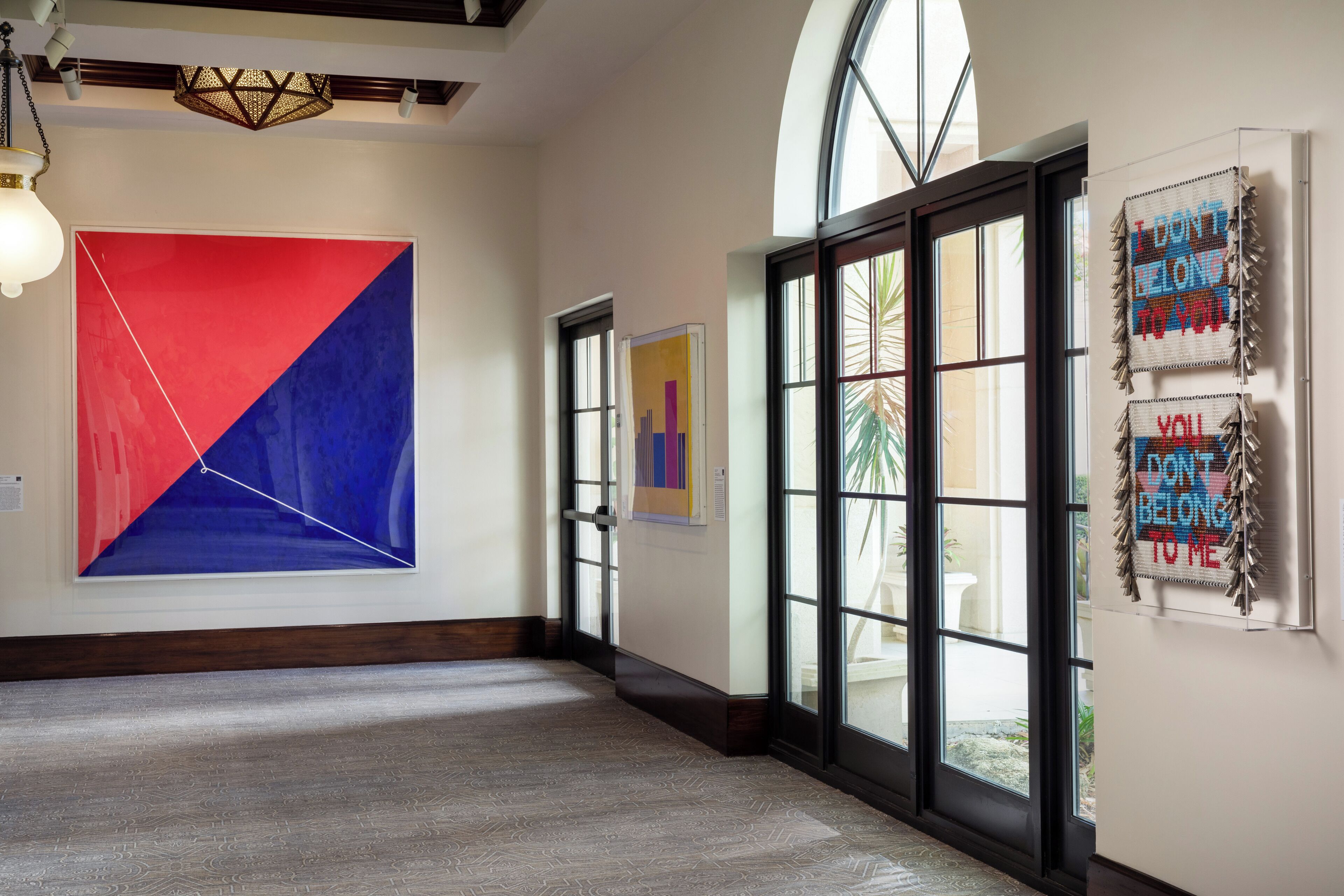 An art gallery with large abstract paintings and a modern interior design.