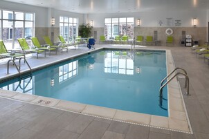 Una piscina techada, sillones reclinables de piscina