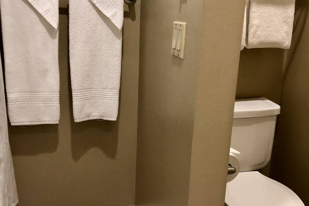 combined shower/bathtub, designer toiletries, hair dryer, bathrobes