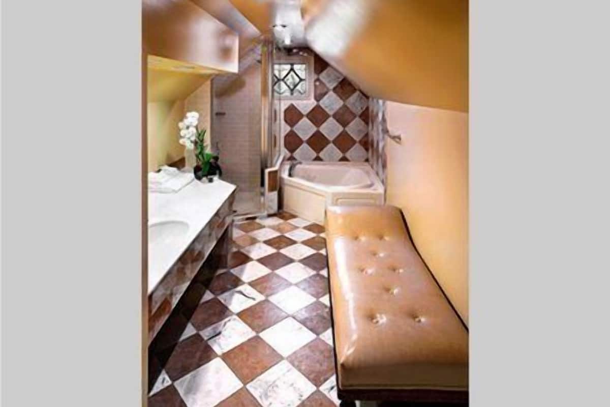 combined shower/bathtub, designer toiletries, hair dryer, bathrobes