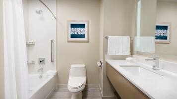 A modern bathroom with a bathtub, toilet, and sink.