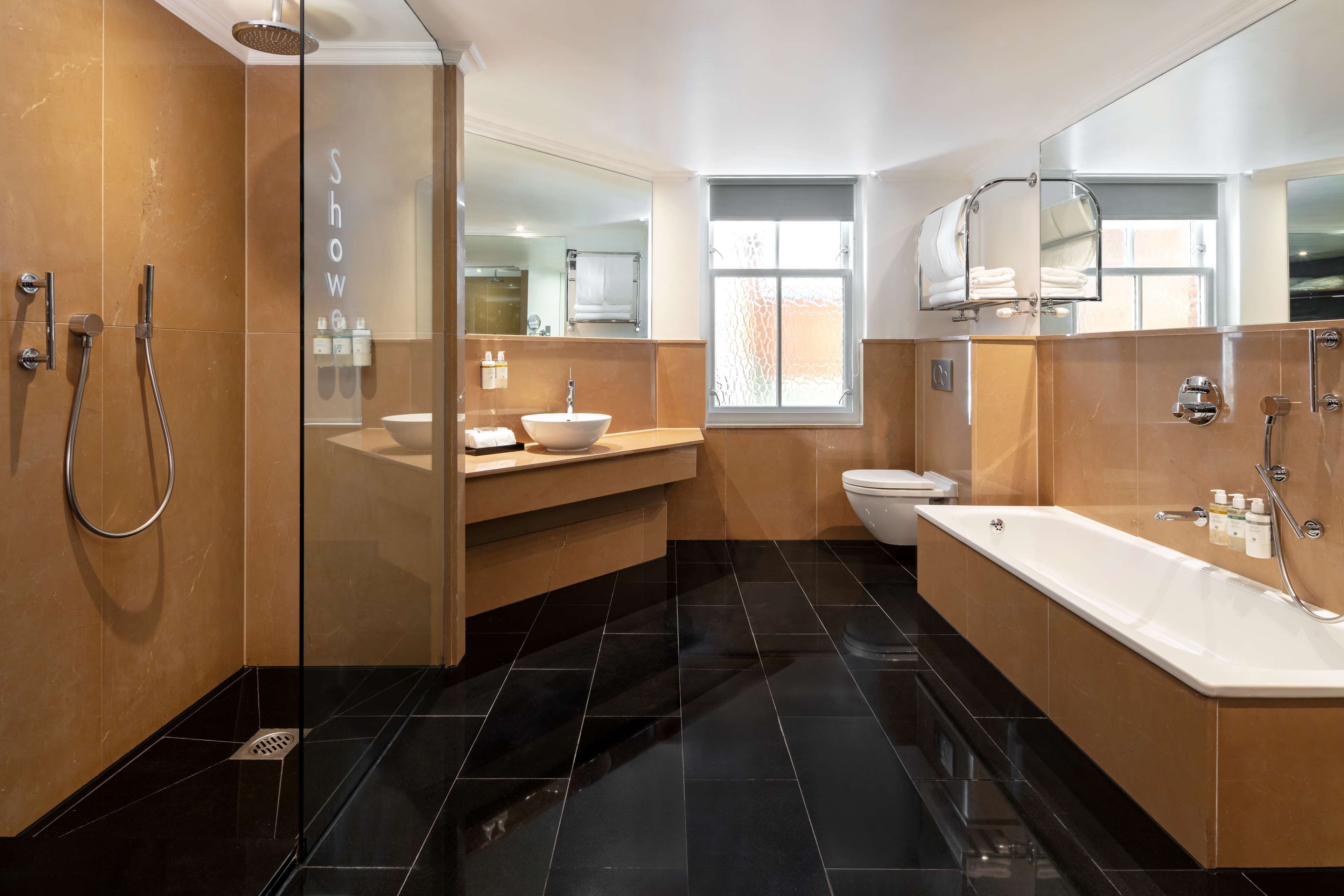 studio suite | bathroom | shower, designer toiletries, hair dryer, towels