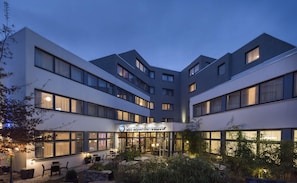 A modern hotel with a courtyard, multiple floors, and a sign reading 'Best Western Ambassador'. - Best Western Hotel Ambassador (Baunatal)