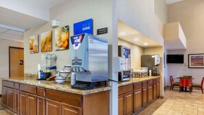 A hotel reception area with a coffee machine, a breakfast sign, and a TV mounted on the wall. - Comfort Inn Payson (Payson)
