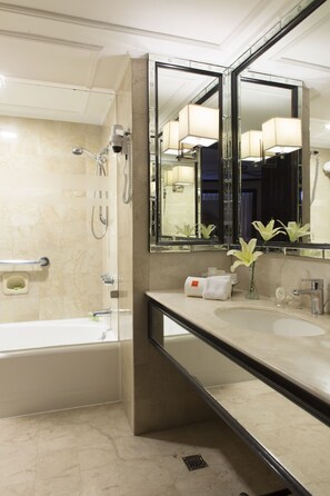 A modern bathroom with a bathtub, a sink, a mirror, and a shower. - Midas Hotel & Casino (Pasay)
