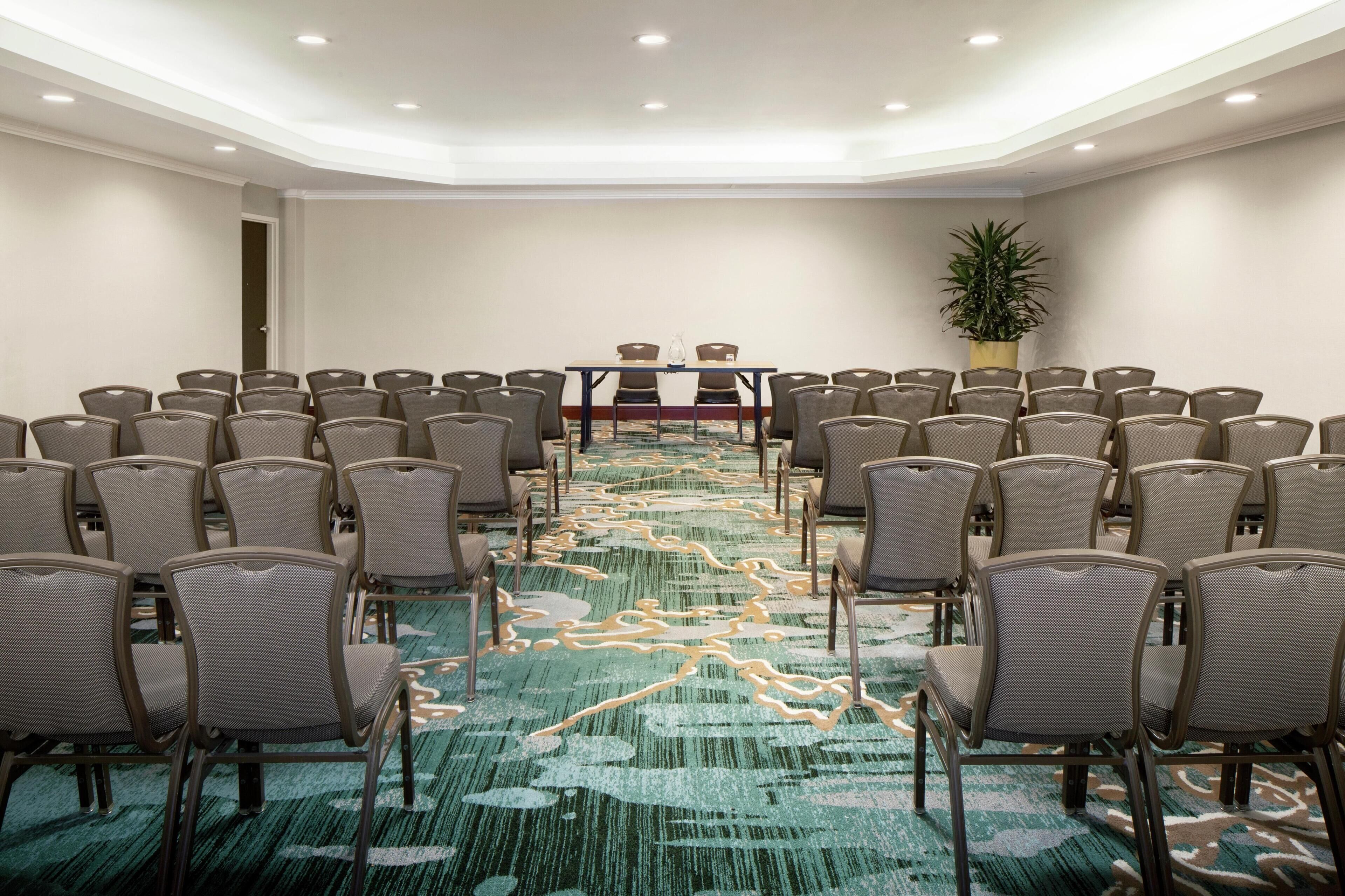 A conference room with a long table and chairs arranged for a meeting.