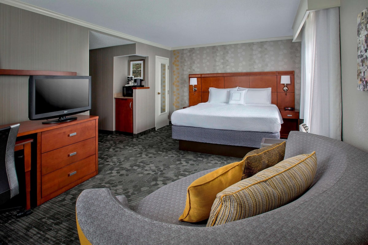 Premium bedding, desk, laptop workspace, iron/ironing board