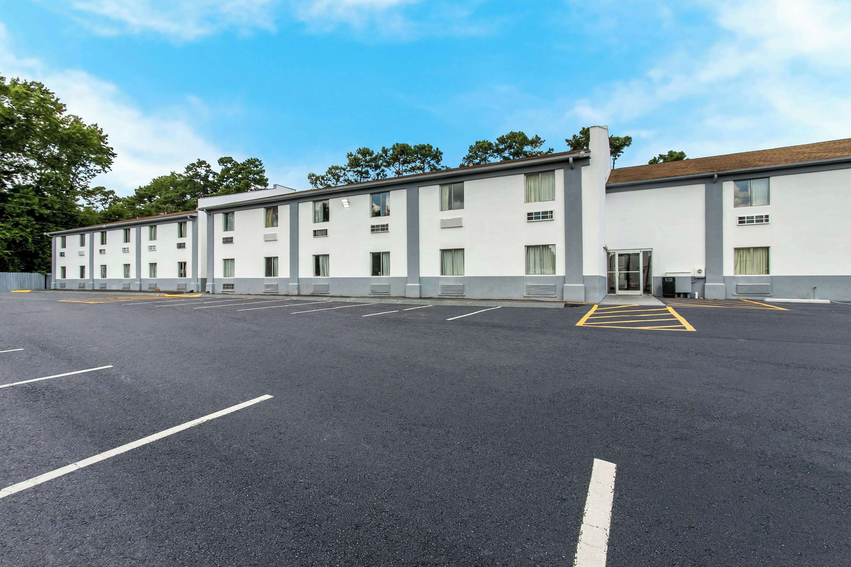 A modern building with a parking lot in front.
