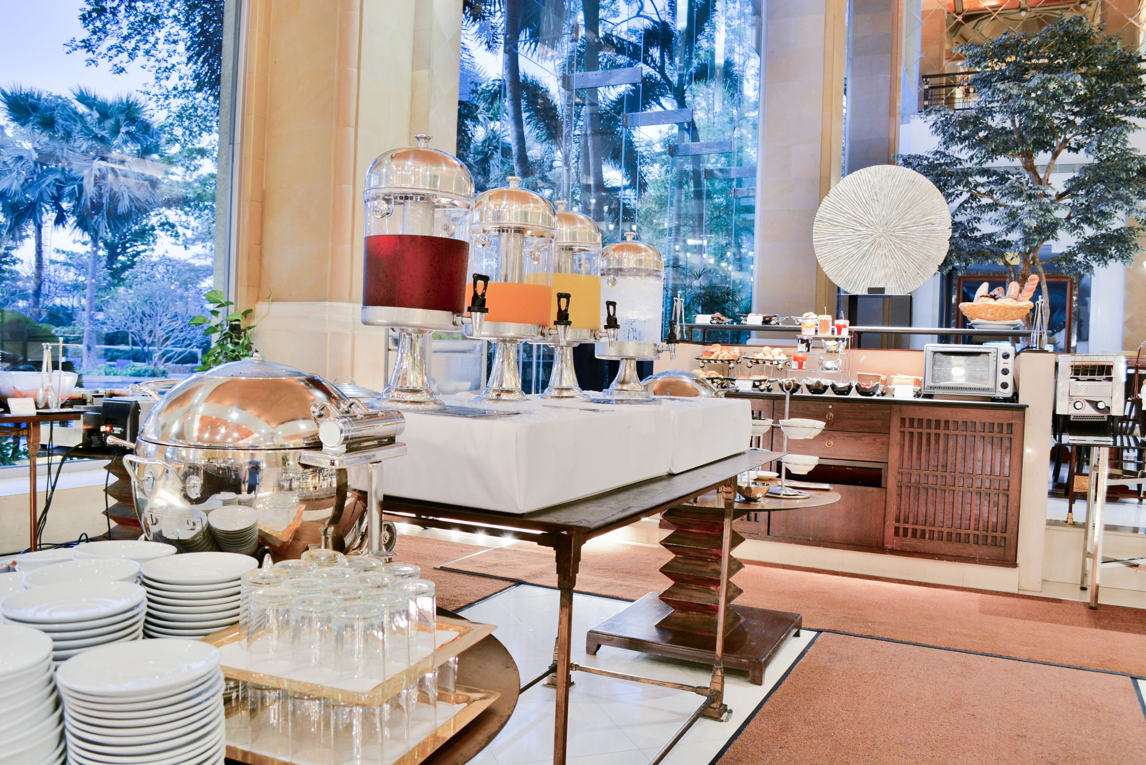 A buffet setup with various food items and serving utensils.