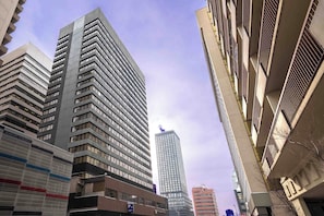 A high-rise building with a modern architectural design, featuring multiple floors and a prominent vertical orientation. - Sandman Signature Calgary Downtown Hotel (Calgary)