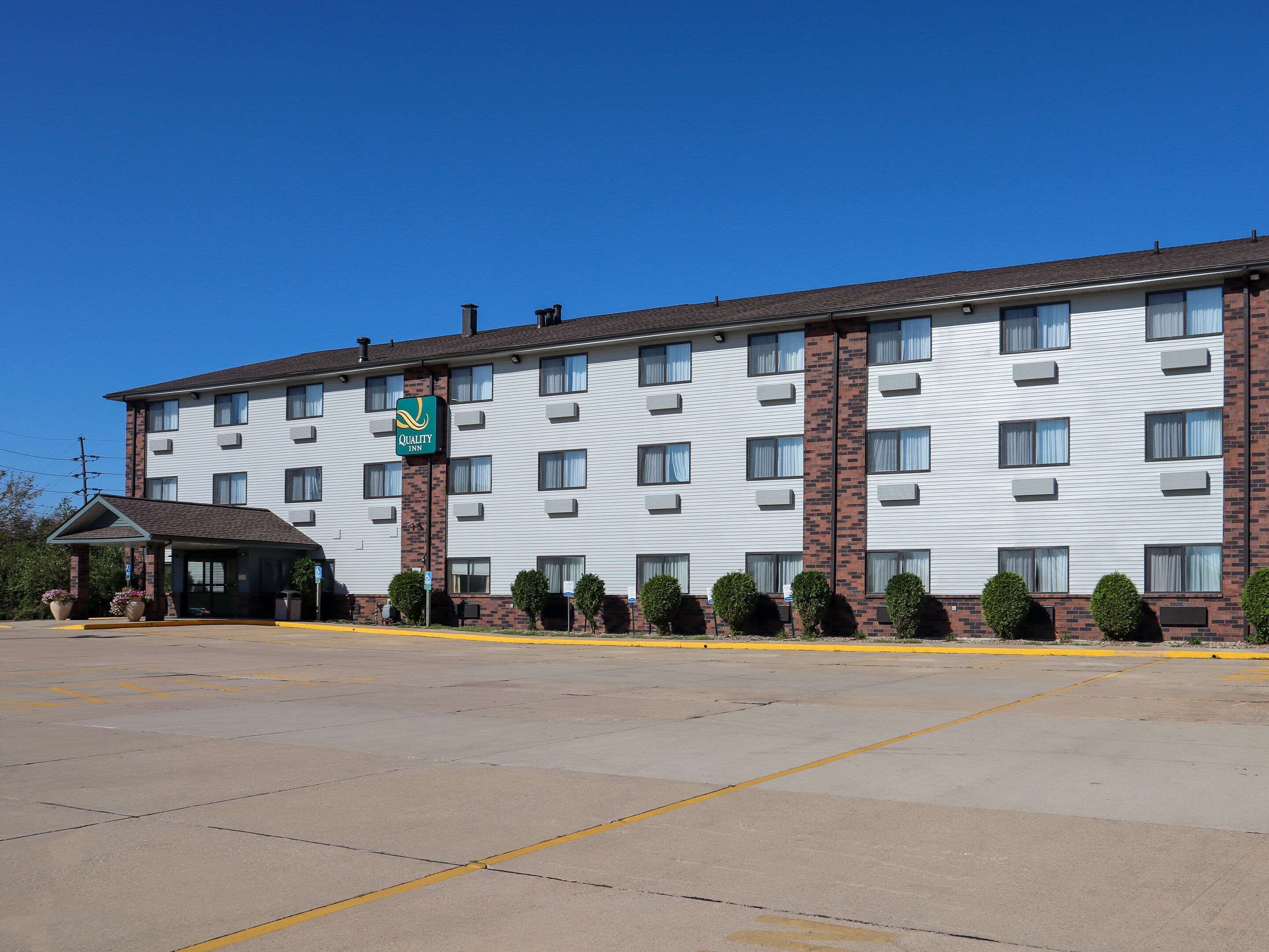 A multi-story hotel with a brick facade and a flat roof.