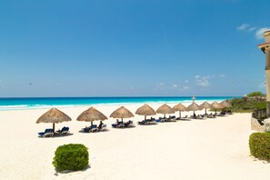 On the beach, sun loungers, beach towels