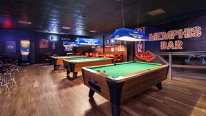 A pool hall with multiple pool tables, a bar area, and neon signs. - Super 8 by Wyndham Longview/North (Longview)