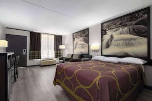 A hotel room with a large bed, a desk, a chair, a TV, and a window with curtains. - Super 8 by Wyndham Longview/North (Longview)