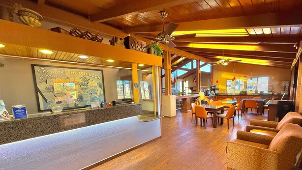 A reception area with a counter, seating area, and a view of the lobby.