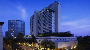 A high-rise hotel with multiple floors, a glass facade, and a flat roof terrace. - New World Makati Hotel (Makati)