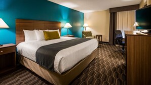 A hotel room with a large bed, two bedside tables, a desk, a chair, and a television. - Best Western Plus Yadkin Valley Inn & Suites (Jonesville)