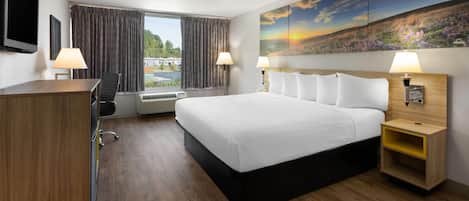 Room, 1 King Bed, Refrigerator & Microwave | Pillowtop beds, desk, blackout drapes, iron/ironing board