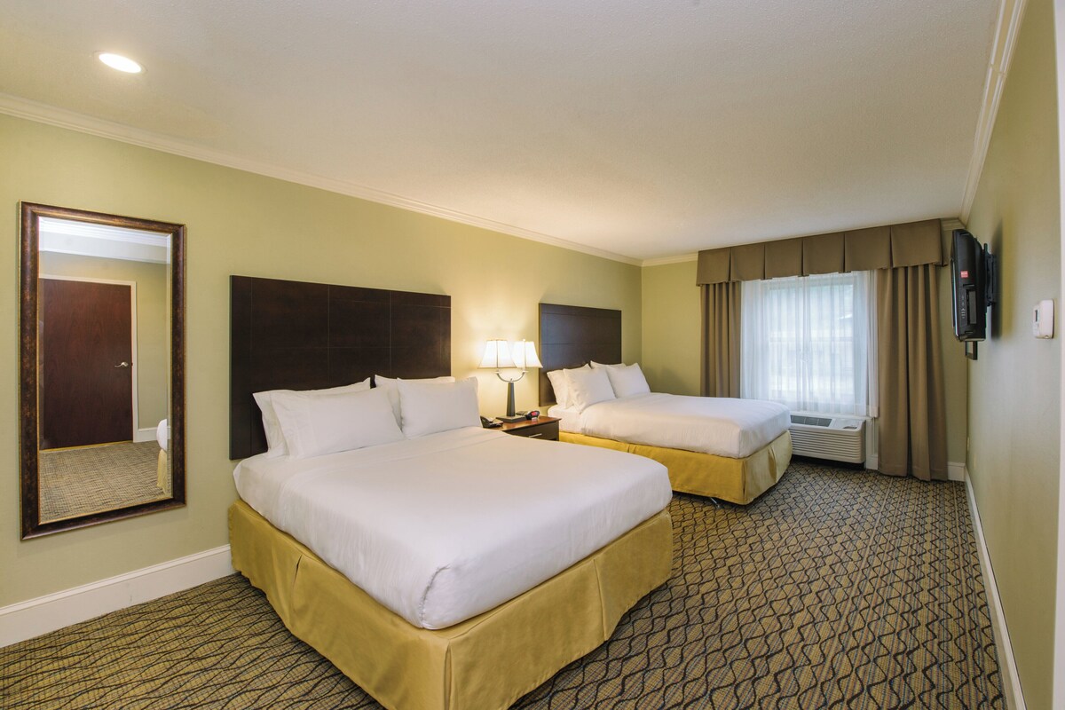 Premium bedding, desk, laptop workspace, blackout drapes