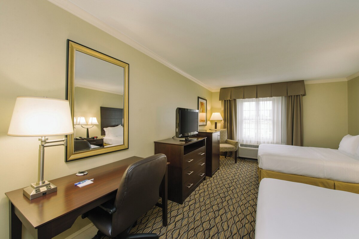 Premium bedding, desk, laptop workspace, blackout drapes