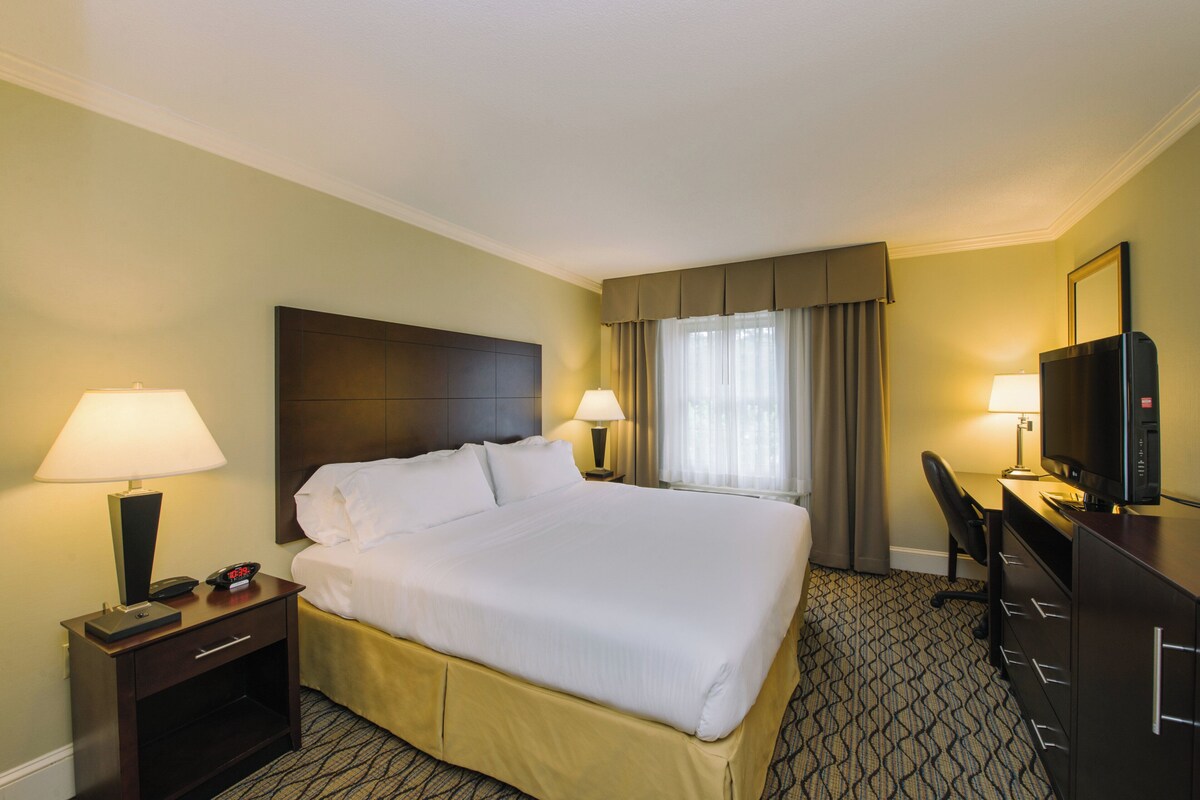 Premium bedding, desk, laptop workspace, blackout drapes