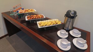 A buffet table with various pastries, beverages, and coffee equipment. - Holiday Inn Monterrey Norte by IHG (San Nicolas de los Garza)