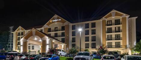 A Comfort Inn hotel with multiple parking spaces and a well-lit entrance.