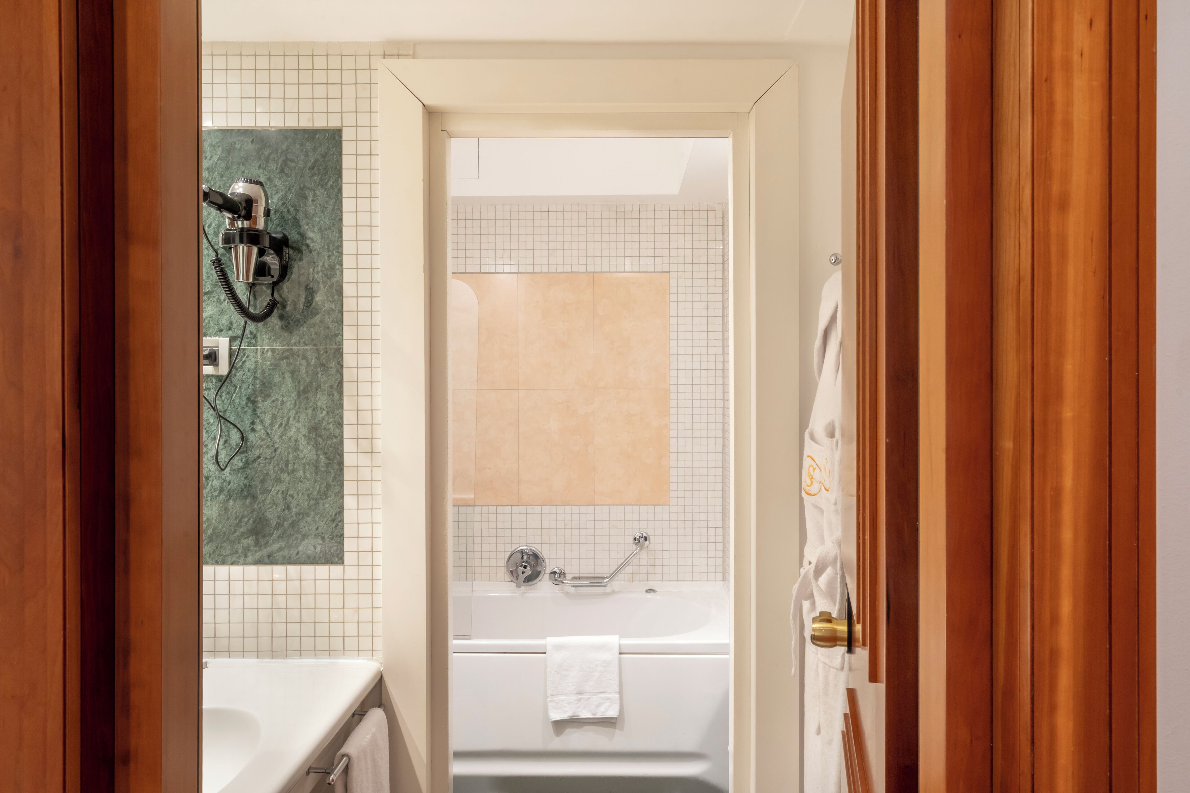 A bathroom with a shower, a bathtub, and a toilet.